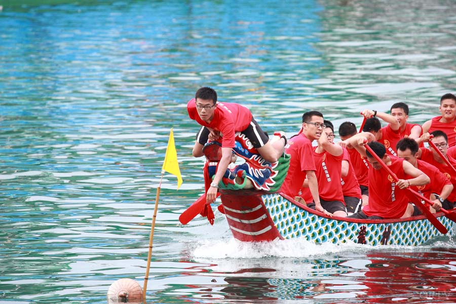 There are 20 paddlers, a drummer, and a steerer in a standard dragon boat.